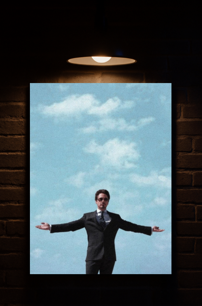 Man in a suit standing with arms outstretched against a blue sky with clouds, framed by a dark brick wall printed on velvet