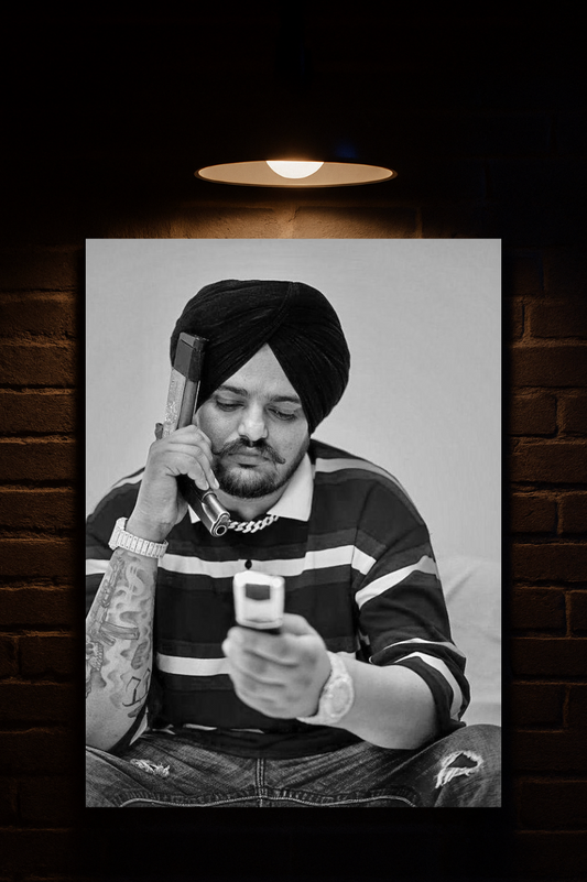 Sidhu Moosewala wearing striped sweater holding a phone against a dark brick wall.